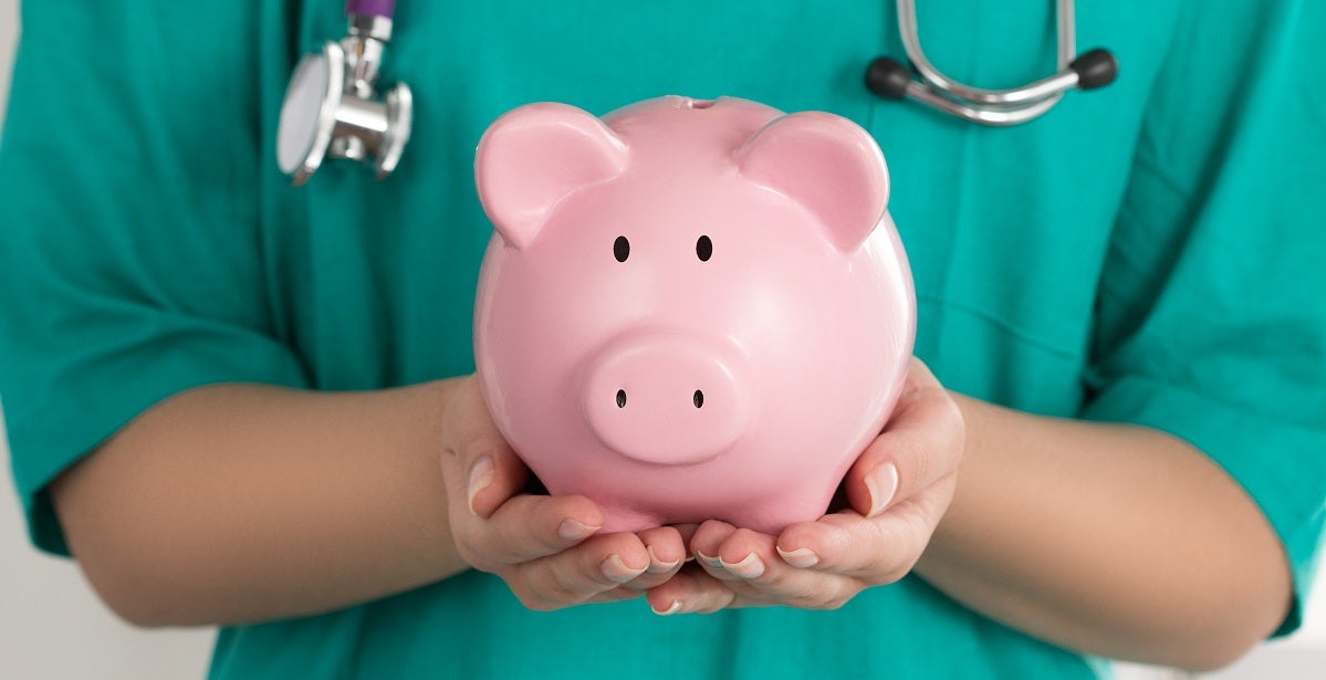 Nurse holding a piggy bank